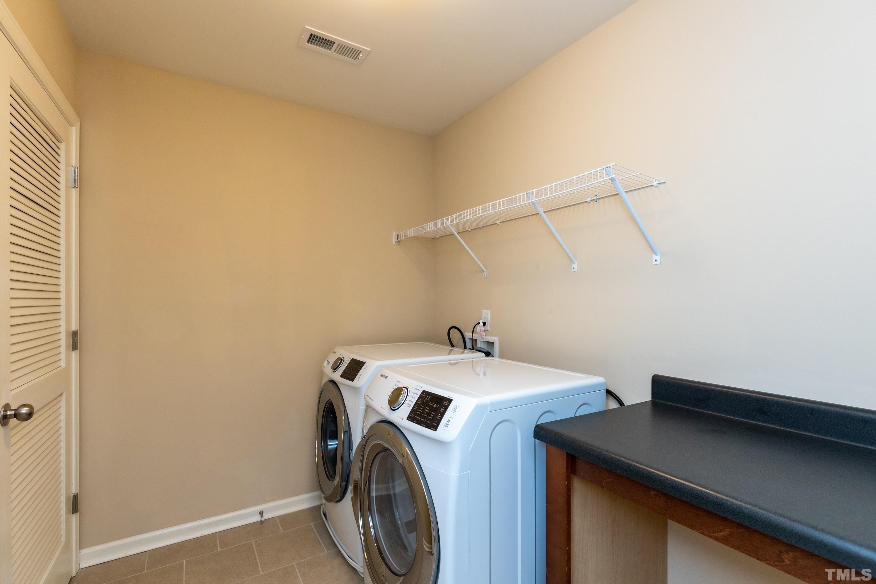 566 Chessie Station Apex, NC 27502 - Photo 27 of 29 a utility room with dryer and washer