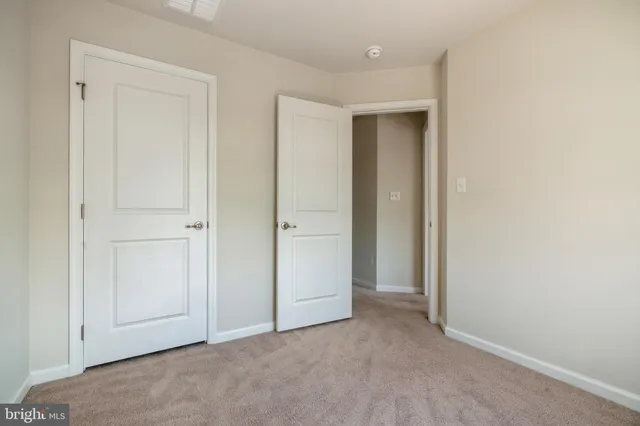 an empty room with closet area