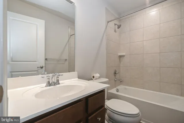 a bathroom with a sink a toilet and bathtub