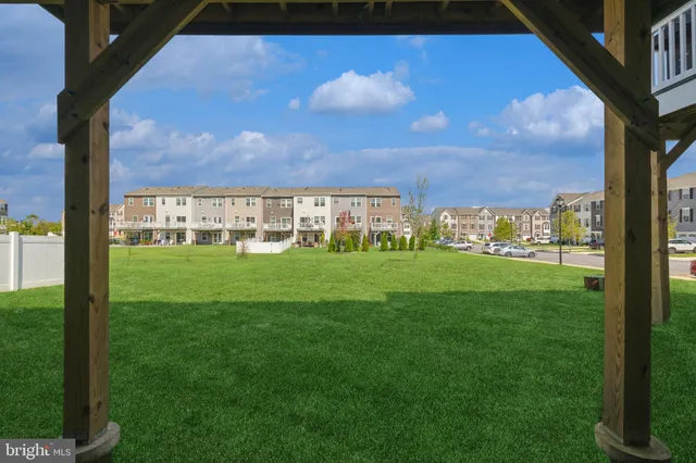 a view of front of a brick house with a yard