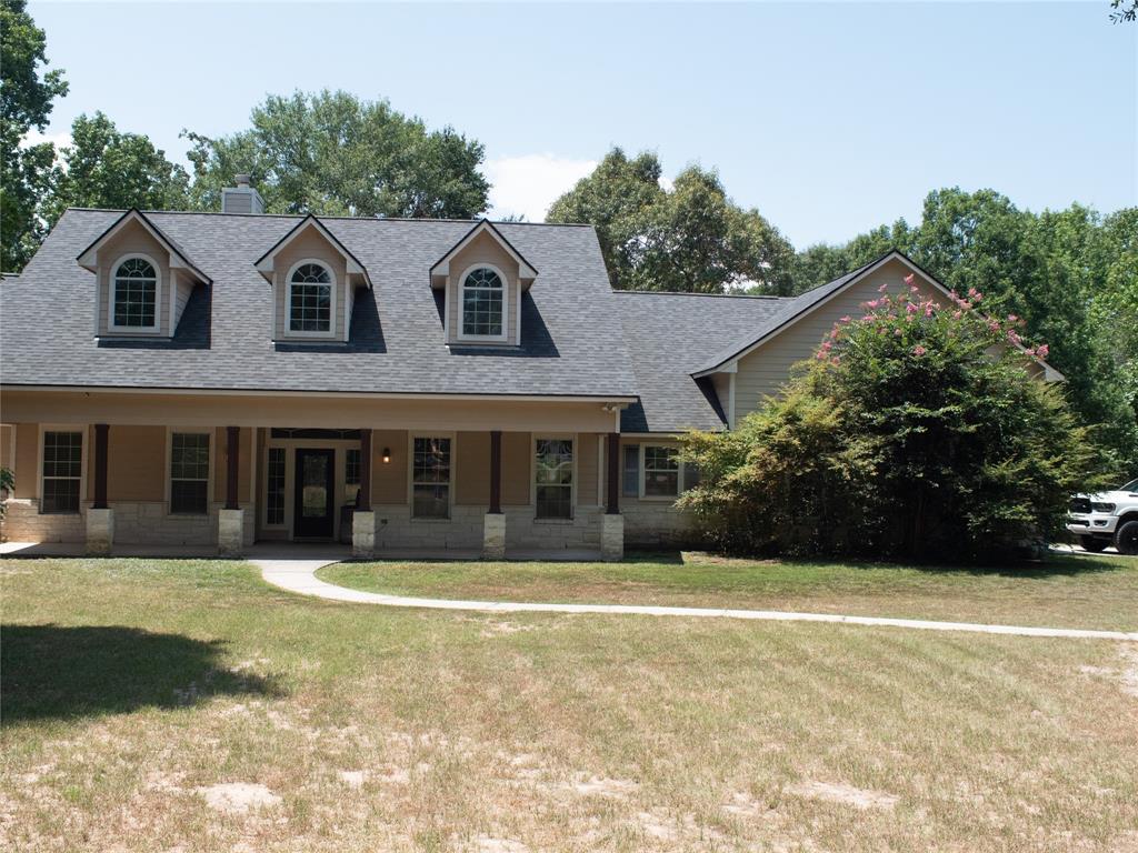 427 Trace Way Drive Montgomery, TX 77316 - Photo 1 of 37 a view of a white house with a large windows and large trees