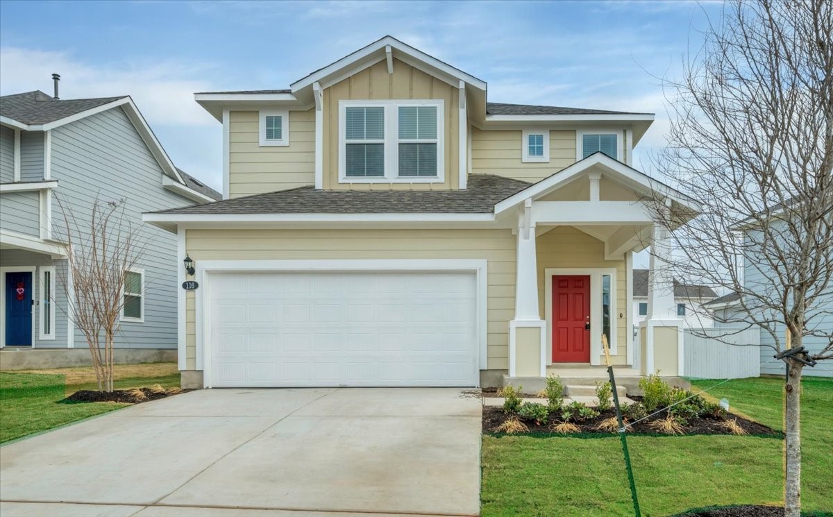 a front view of a house with a yard and garage
