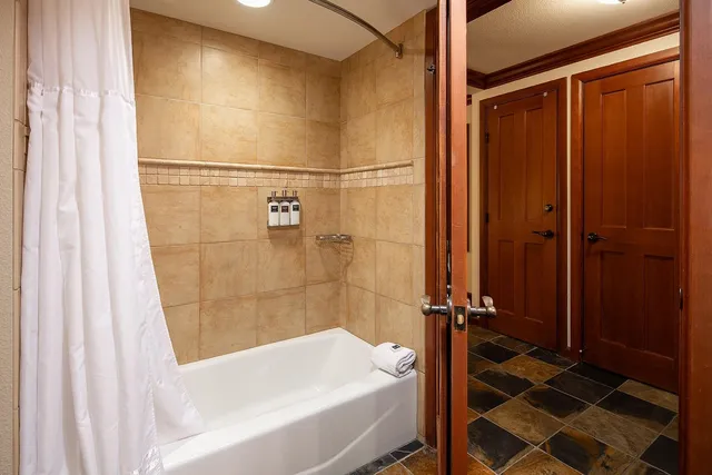 a bathroom with a bathtub and a shower