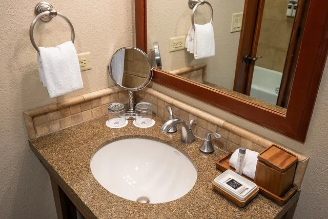 wooden floor with view of bathroom
