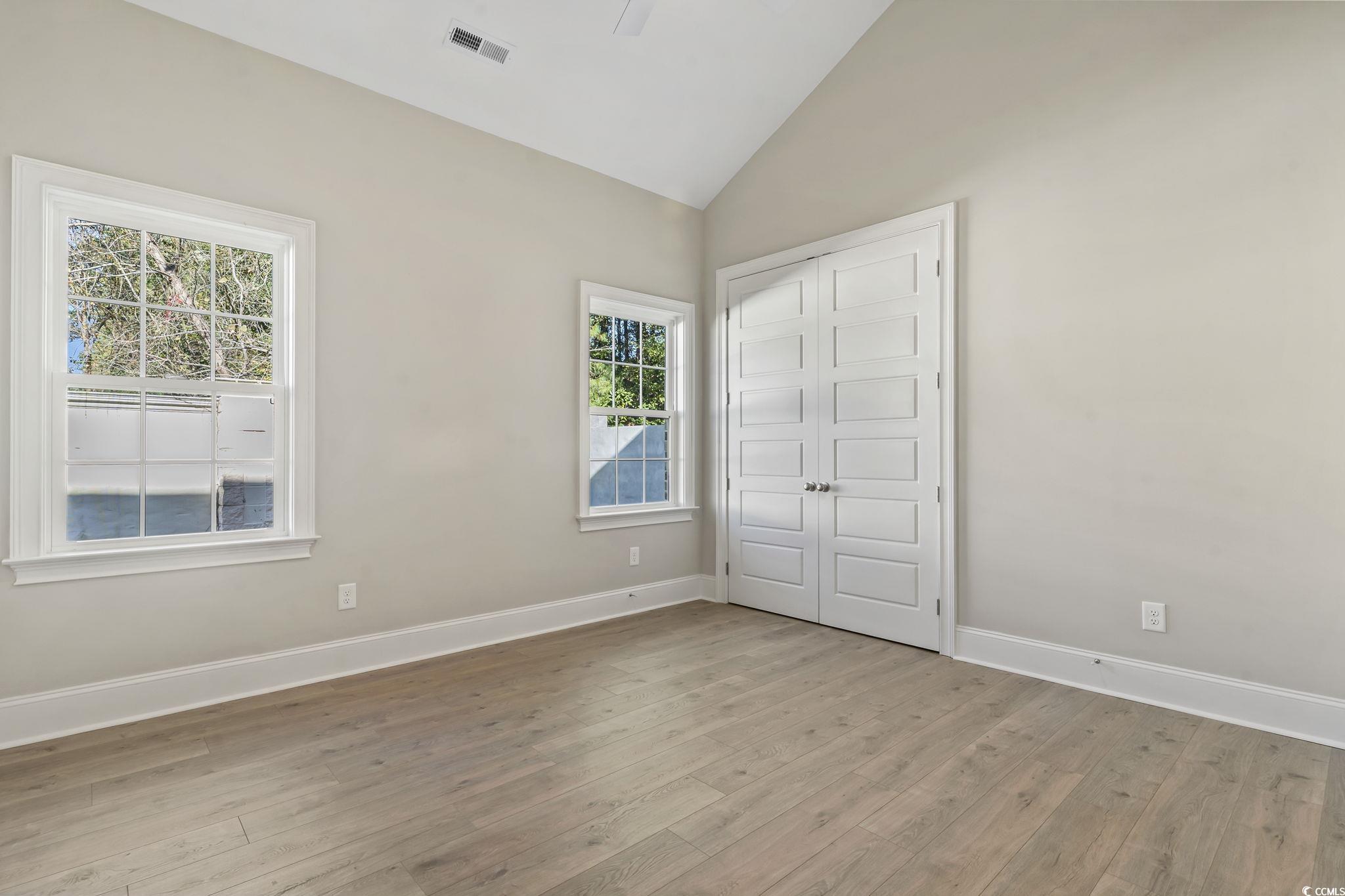 329 Waterfall Circle Little River, SC 29566 - Photo 23 of 39 Unfurnished bedroom featuring vaulted ceiling, light wood-type flooring, a closet, and ceiling fan