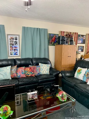 a spacious bedroom with a bed and a chandelier