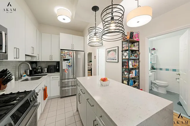 a living room with furniture and a painting on the wall