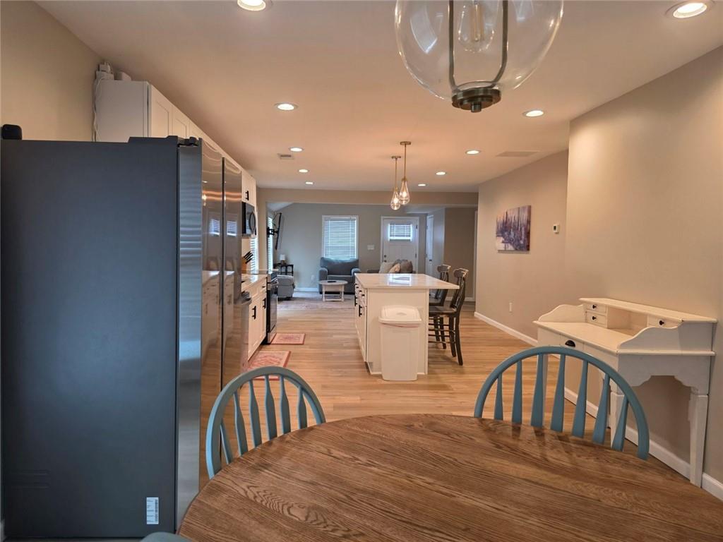 722 Lacy Street Monroe, GA 30655 - Photo 12 of 19 a dining room with furniture a chandelier and wooden floor