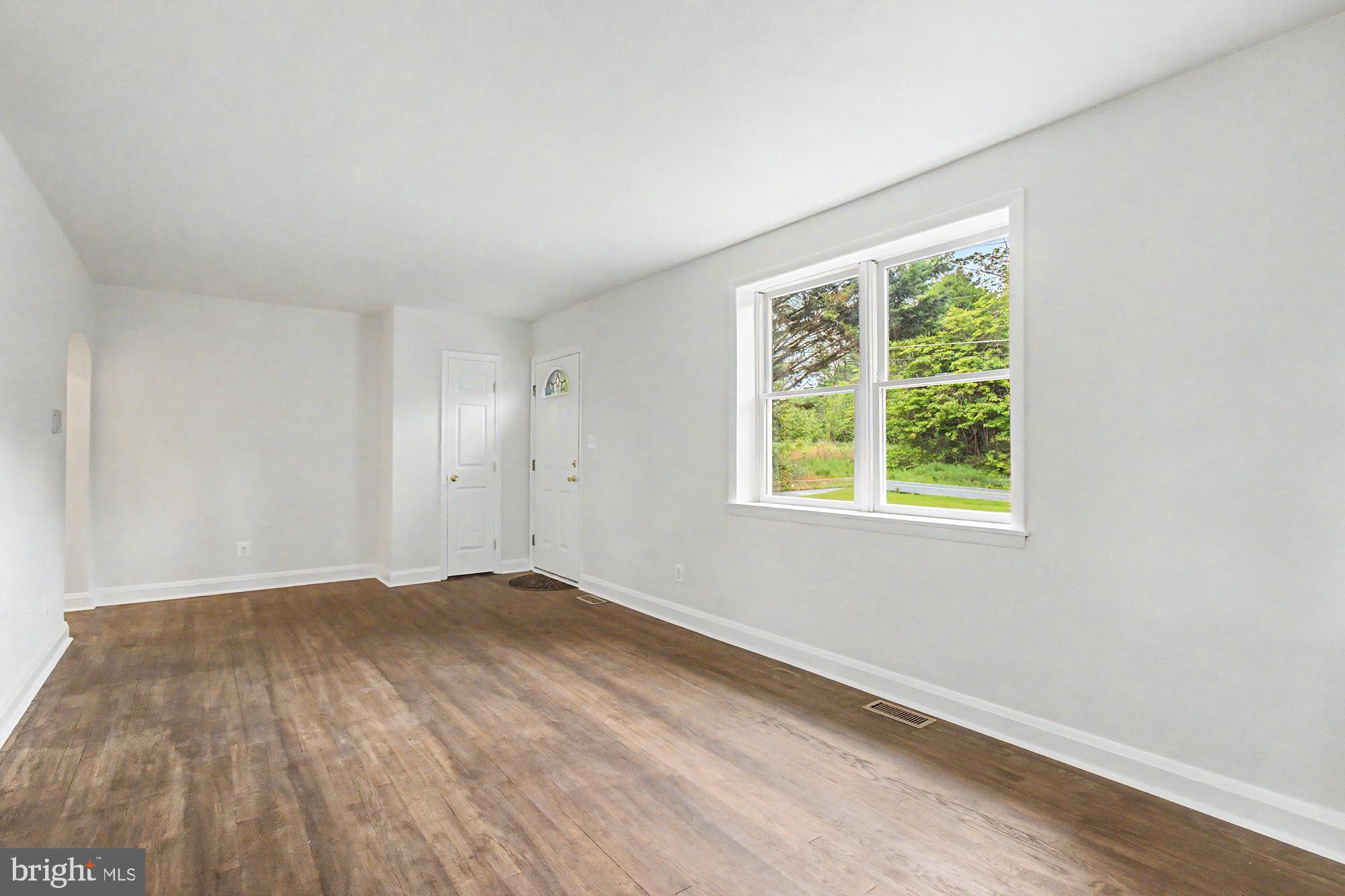604 Prospect Mill Road Bel Air, MD 21015 - Photo 7 of 36 an empty room with wooden floor and windows