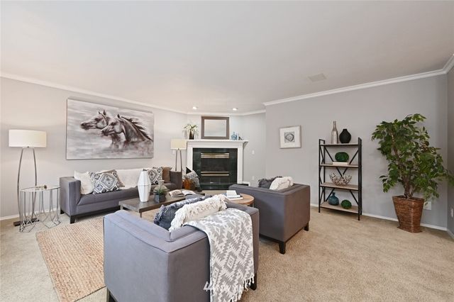 a living room with furniture potted plant and a fireplace