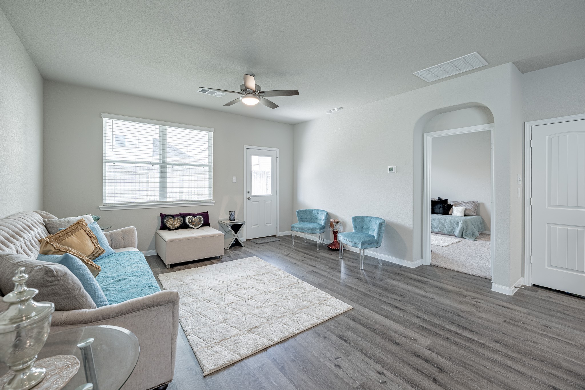 4923 Blue Jacaranda Way Spring Spring, TX 77373 - Photo 11 of 25 a spacious bedroom with a bed a couch and wooden floor