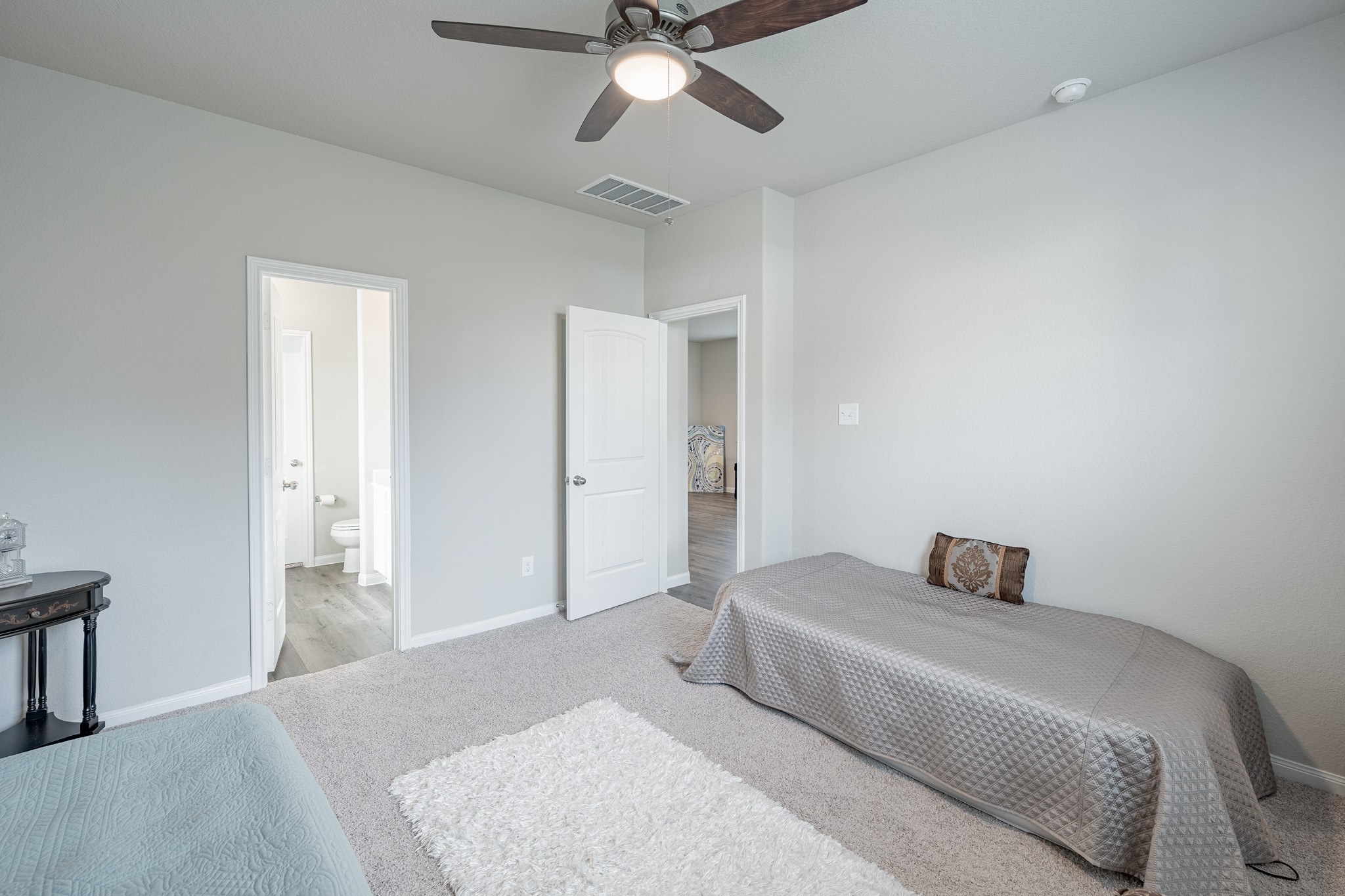 4923 Blue Jacaranda Way Spring Spring, TX 77373 - Photo 12 of 25 a bedroom with a bed and a chandelier