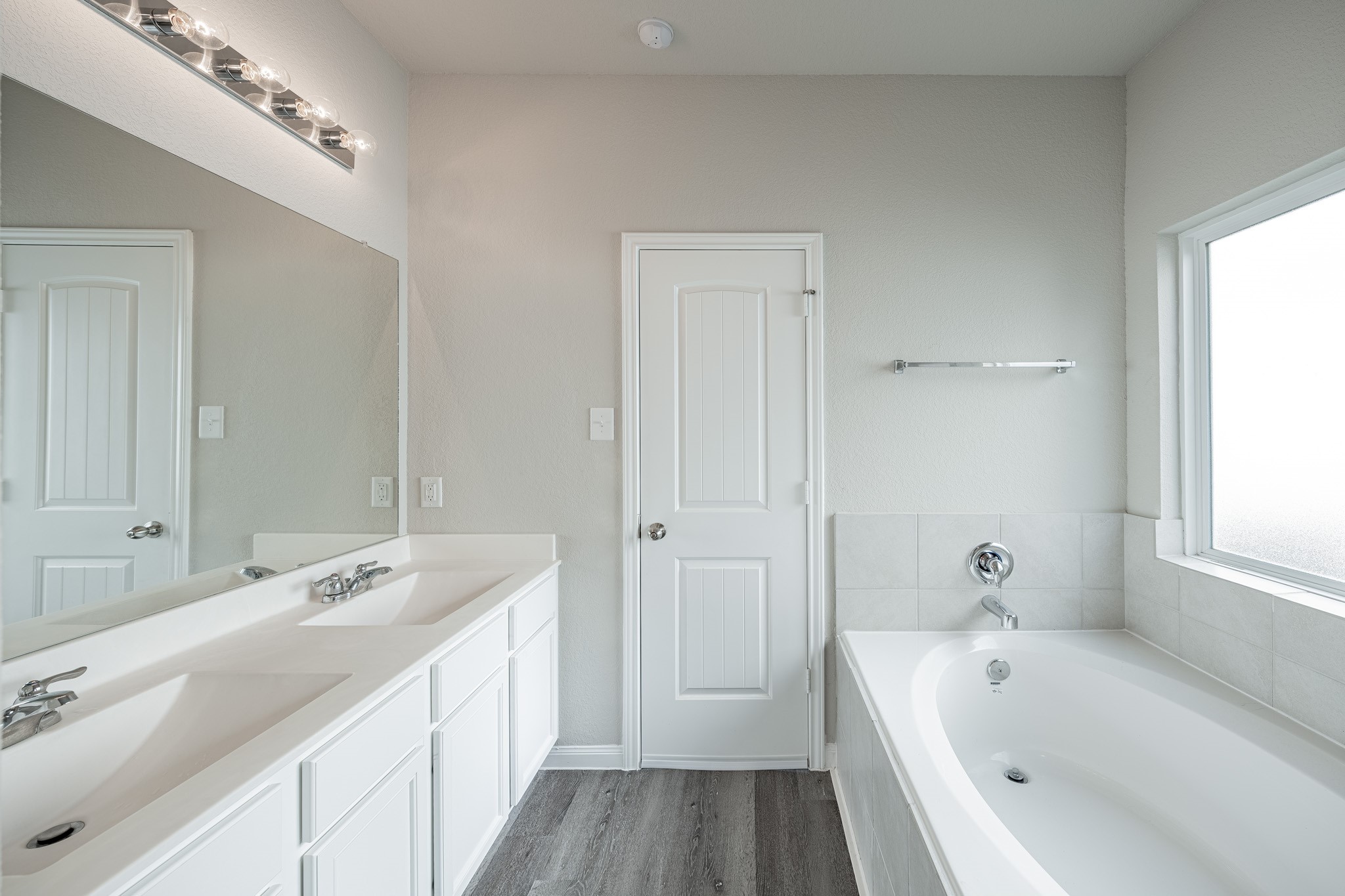 4923 Blue Jacaranda Way Spring Spring, TX 77373 - Photo 14 of 25 a bathroom with a tub a sink and mirror