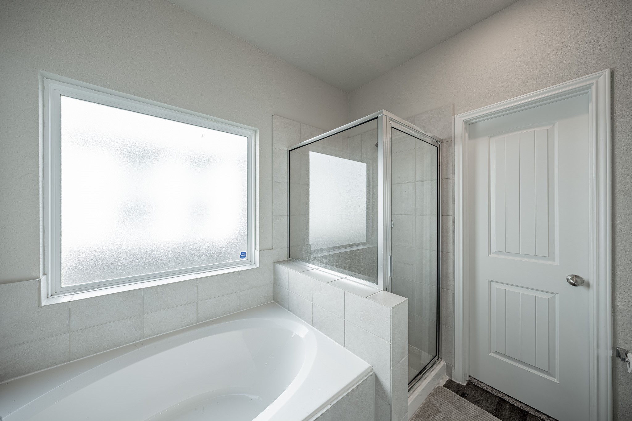 4923 Blue Jacaranda Way Spring Spring, TX 77373 - Photo 15 of 25 a bathroom with a bathtub and a shower