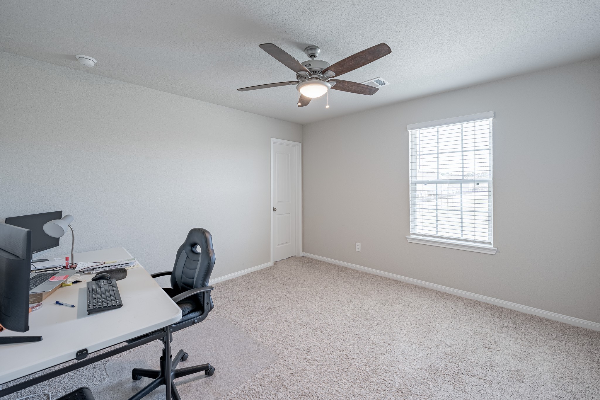 4923 Blue Jacaranda Way Spring Spring, TX 77373 - Photo 20 of 25 a view of a workspace with furniture and a window