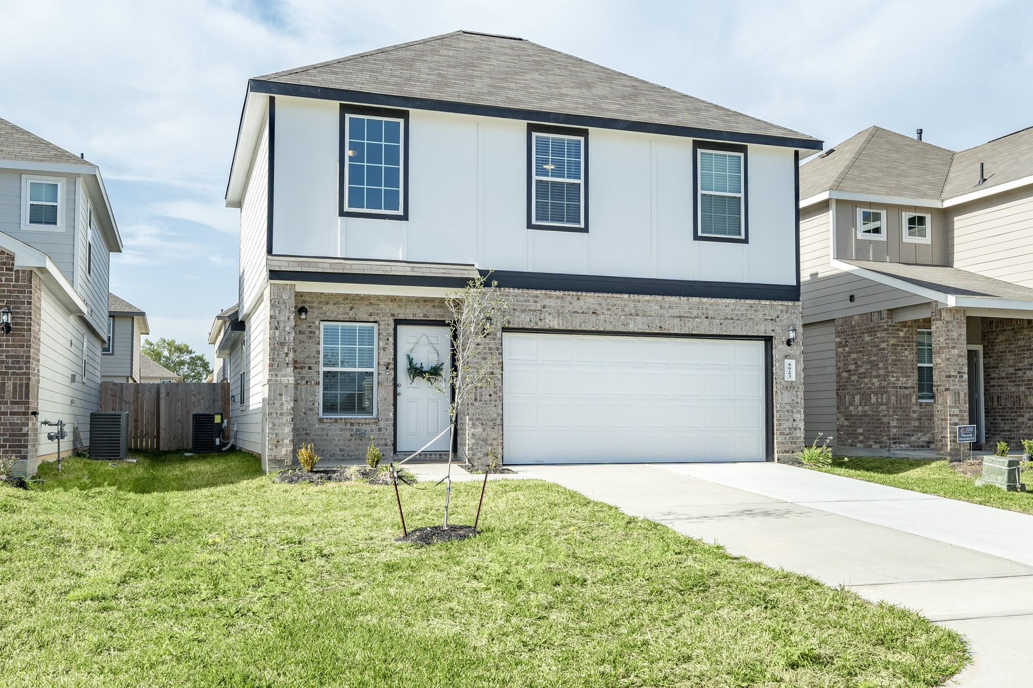 4923 Blue Jacaranda Way Spring Spring, TX 77373 - Photo 2 of 25 a front view of a house with a yard and garage