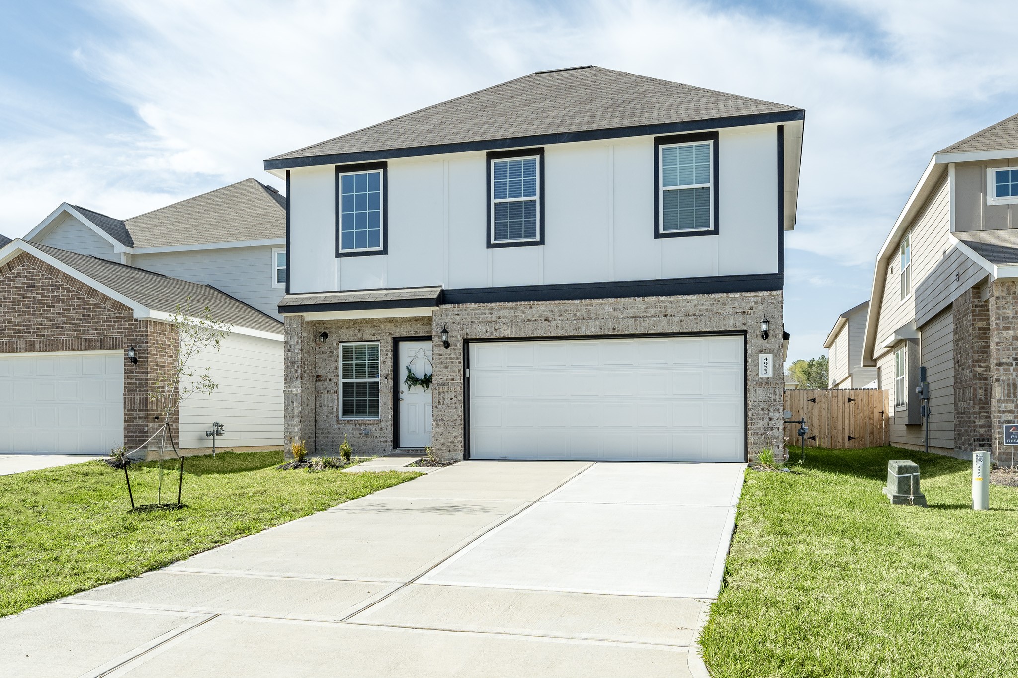 4923 Blue Jacaranda Way Spring Spring, TX 77373 - Photo 3 of 25 a front view of a house with a yard and garage