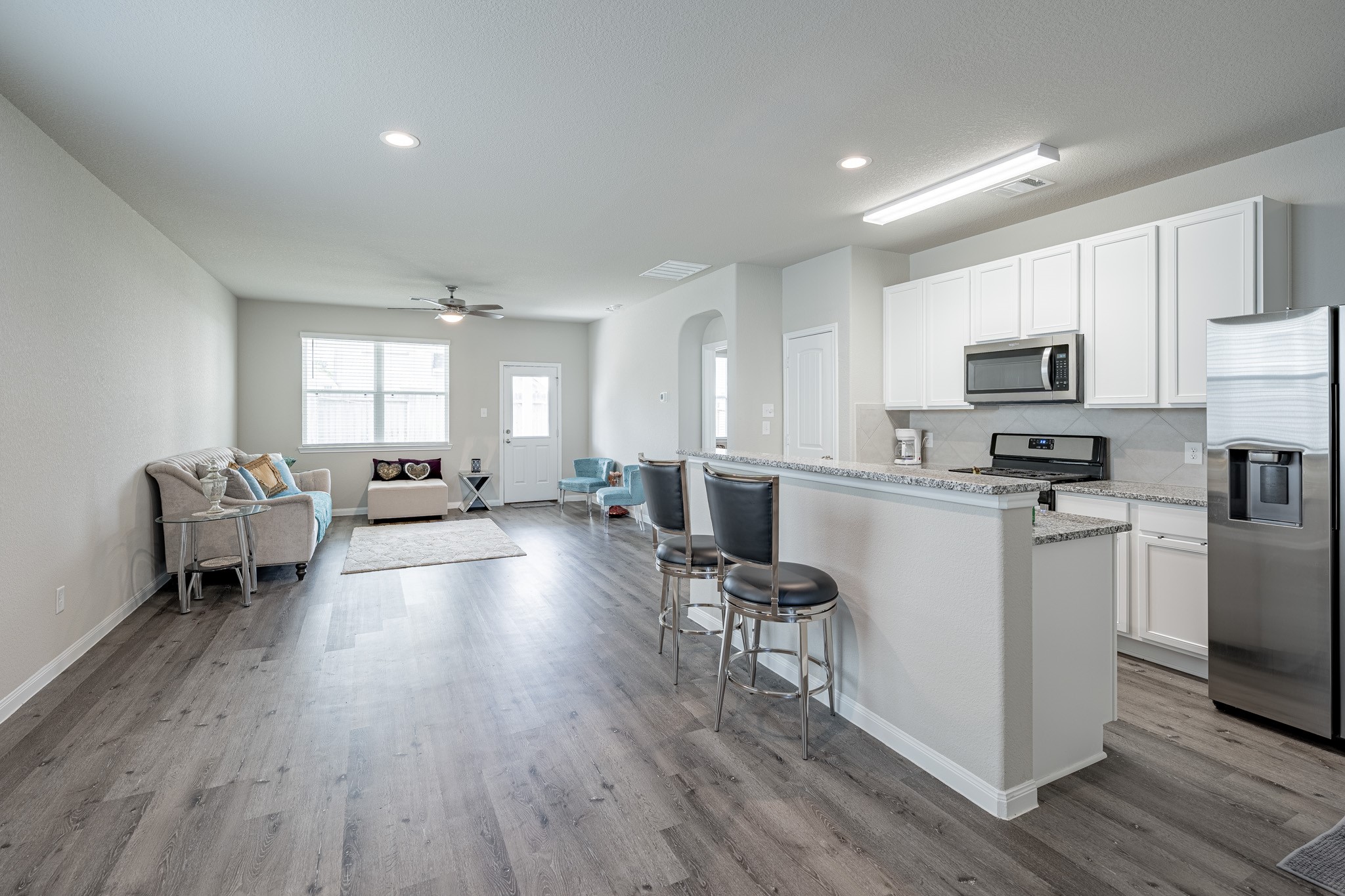 4923 Blue Jacaranda Way Spring Spring, TX 77373 - Photo 7 of 25 a kitchen with sink refrigerator and cabinets