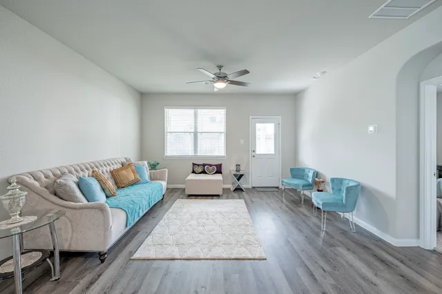 a living room with furniture and a large window