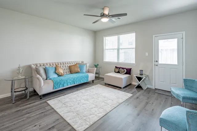 a bedroom with a couch and wooden floor