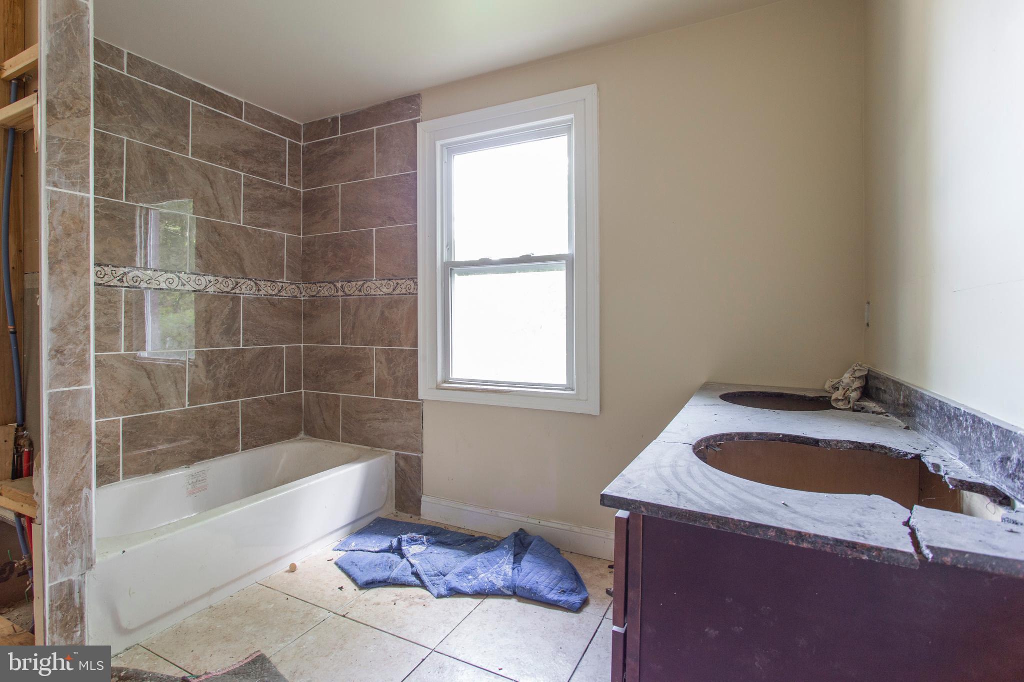 5200 Overbrook Avenue Philadelphia, PA 19131 - Photo 22 of 37 a bath tub sitting next to a window