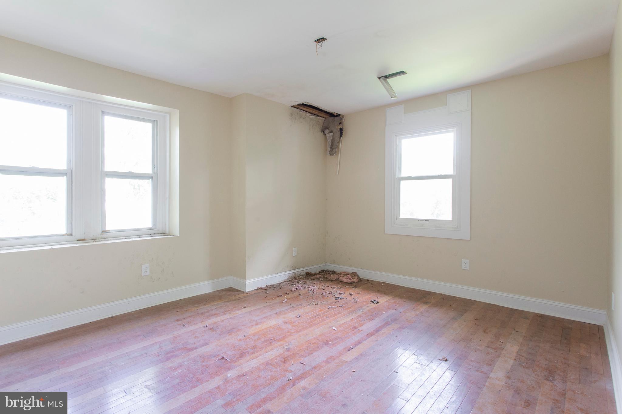 5200 Overbrook Avenue Philadelphia, PA 19131 - Photo 28 of 37 an empty room with wooden floor and windows