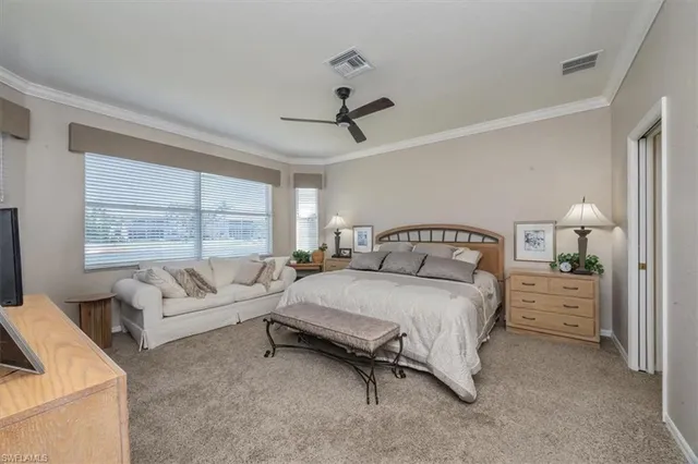 a spacious bedroom with a bed a couch and a window
