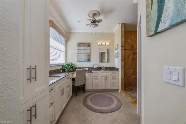 a bathroom with a granite countertop sink mirror and a bathtub