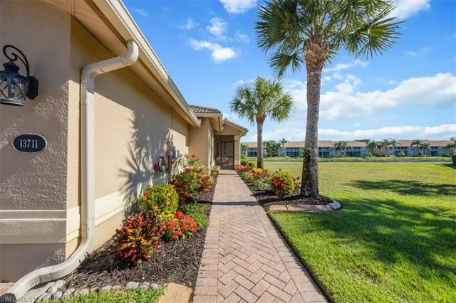 a front view of a house with a garden and patio