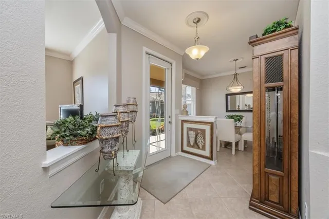 a view of a dining room and livingroom with furniture wooden floor a chandelier