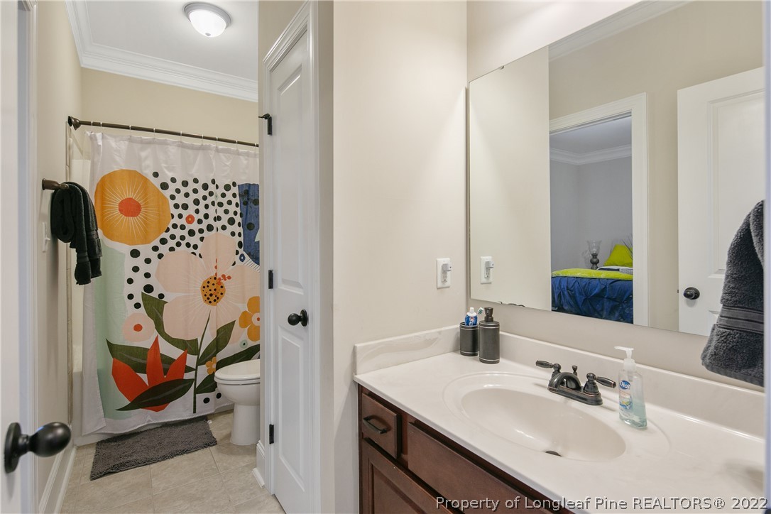 180 The Inner Circle Spring Lake, NC 28390 - Photo 25 of 50 a bathroom with a sink and mirror