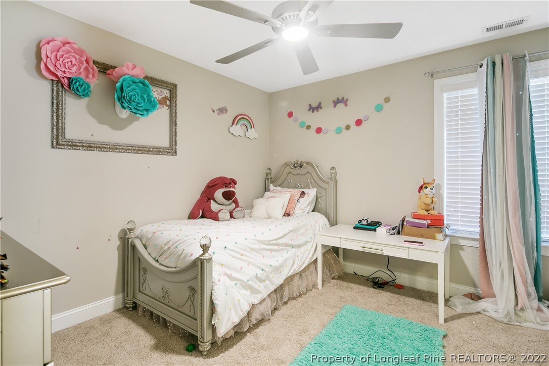 180 The Inner Circle Spring Lake, NC 28390 - Photo 35 of 50 a bedroom with a bed and a window