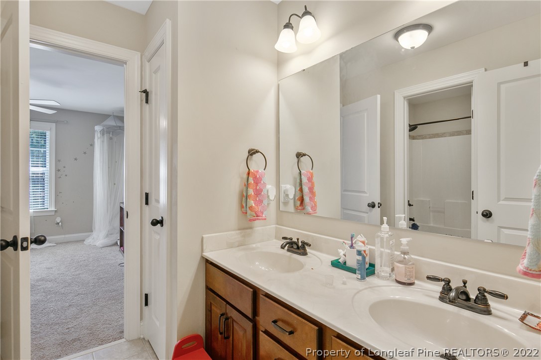 180 The Inner Circle Spring Lake, NC 28390 - Photo 37 of 50 a bathroom with a double vanity sink mirror and double