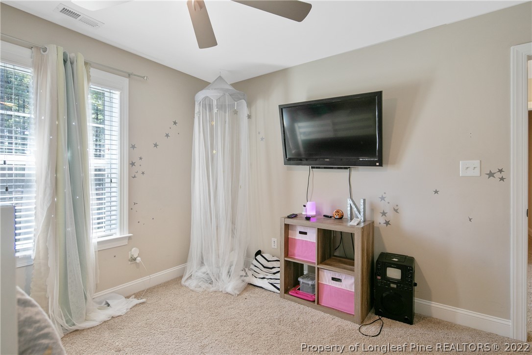 180 The Inner Circle Spring Lake, NC 28390 - Photo 39 of 50 a living room with furniture and a flat screen tv