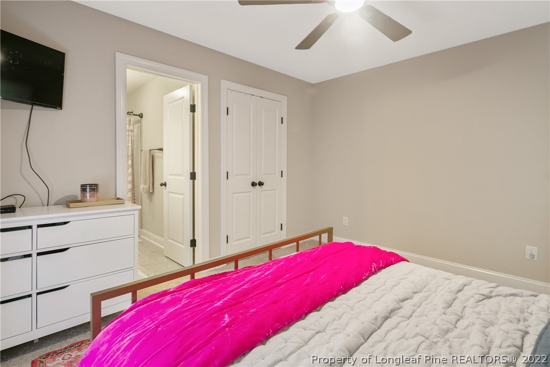 180 The Inner Circle Spring Lake, NC 28390 - Photo 44 of 50 a bedroom with a bed and a flat tv screen