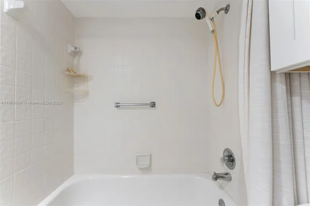 a bathroom with a shower and a bath tub