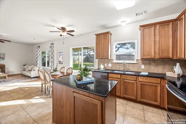 a kitchen with a sink stove and cabinets