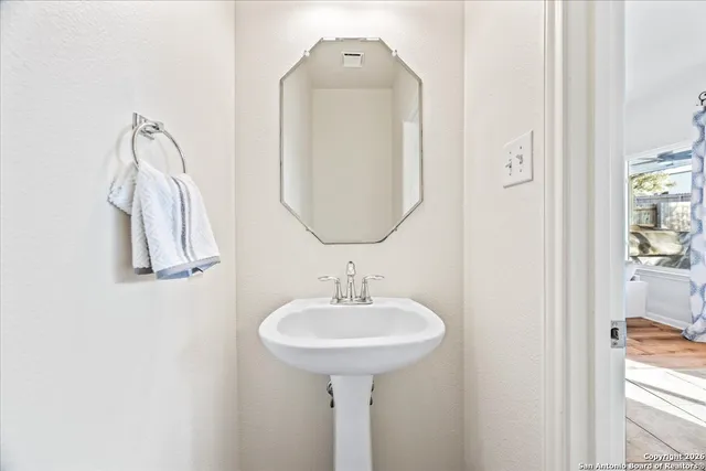 a bathroom with a sink and a mirror