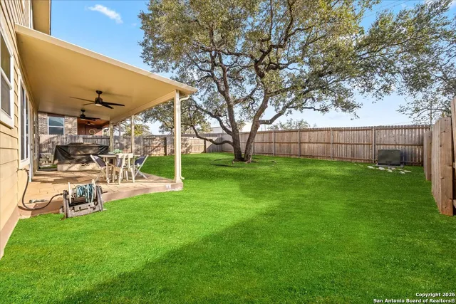a view of a backyard with table and chairs and a small cabin