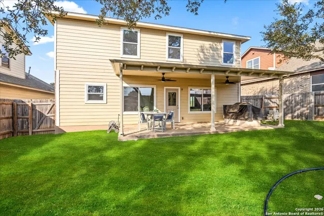 a front view of a house with patio and garden