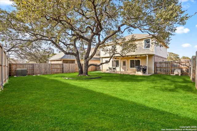 a view of house with yard and green space