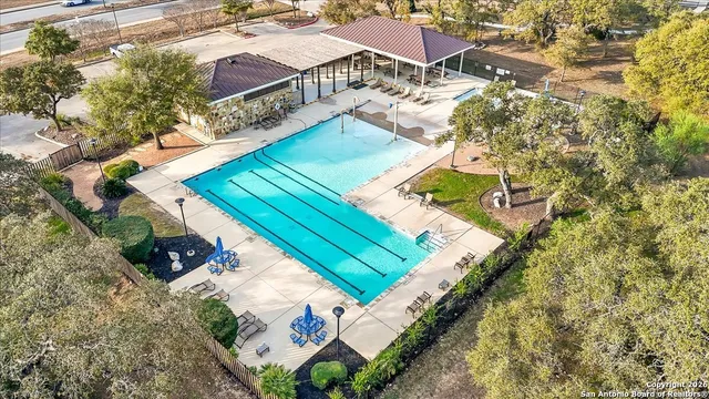 swimming pool view with a seating space