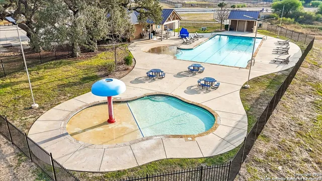 a view of a park with swings and a bench
