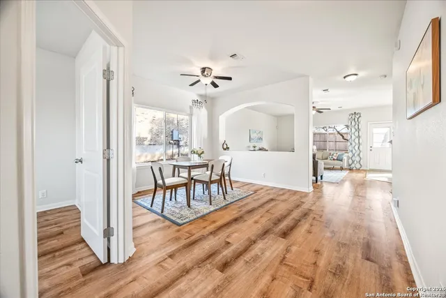 a view of a livingroom with furniture wooden floor a chandelier