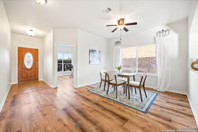 a view of a dining room with furniture window and wooden floor