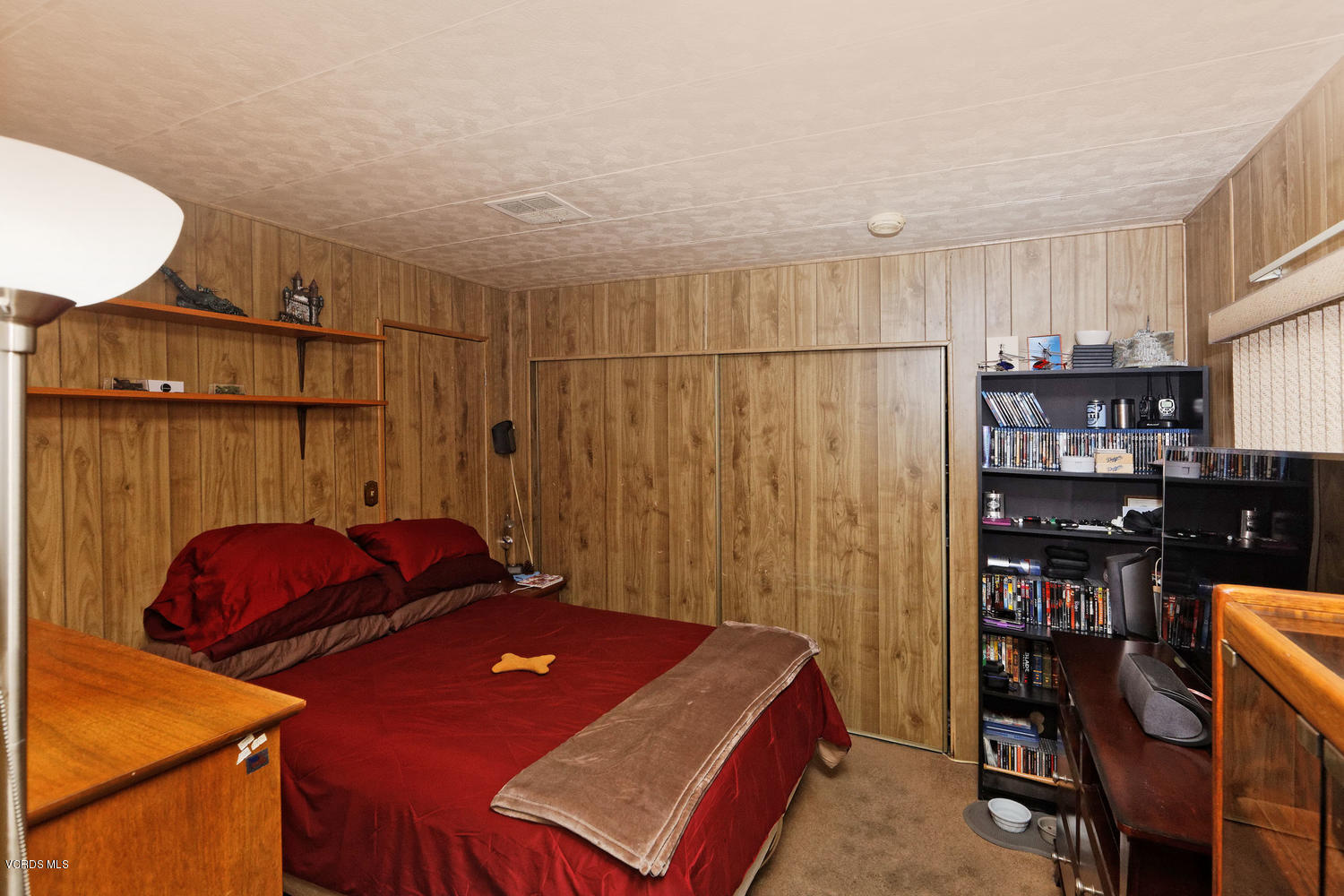 6480 Katherine Road, Unit 5 Simi Valley, CA 93063 - Photo 17 of 32 a bed room with a bed and a book shelf