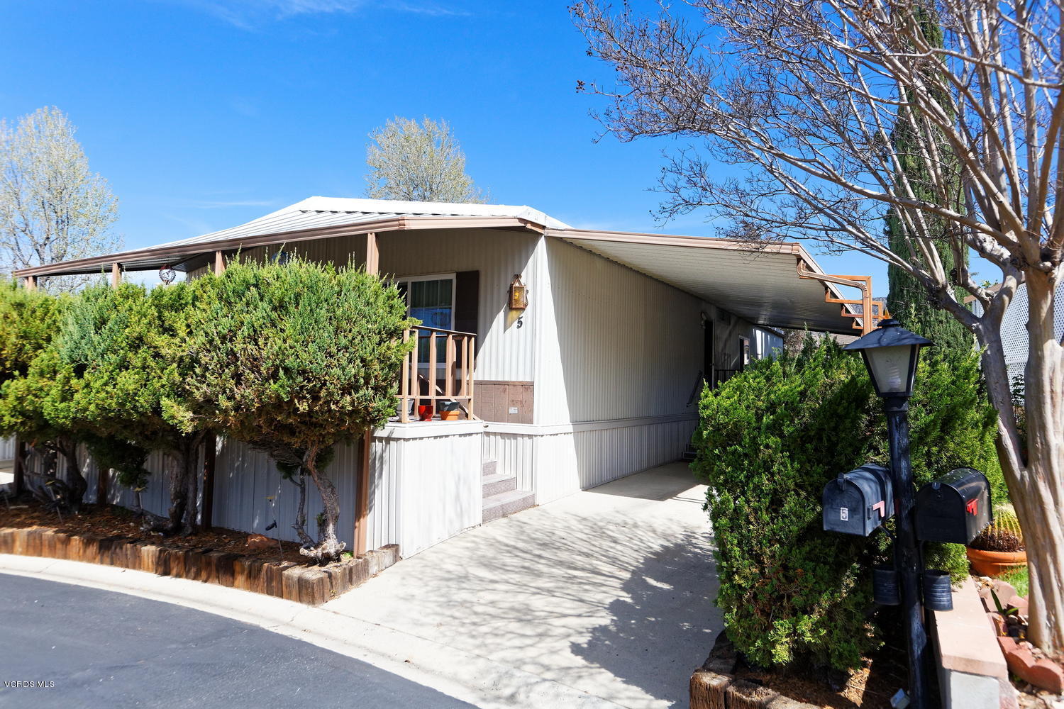 6480 Katherine Road, Unit 5 Simi Valley, CA 93063 - Photo 3 of 32 a front view of a house with a yard