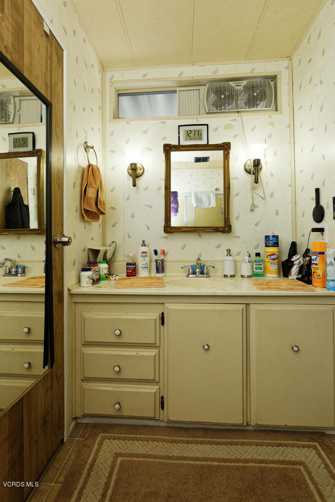 6480 Katherine Road, Unit 5 Simi Valley, CA 93063 - Photo 22 of 32 a bathroom with a sink and a mirror