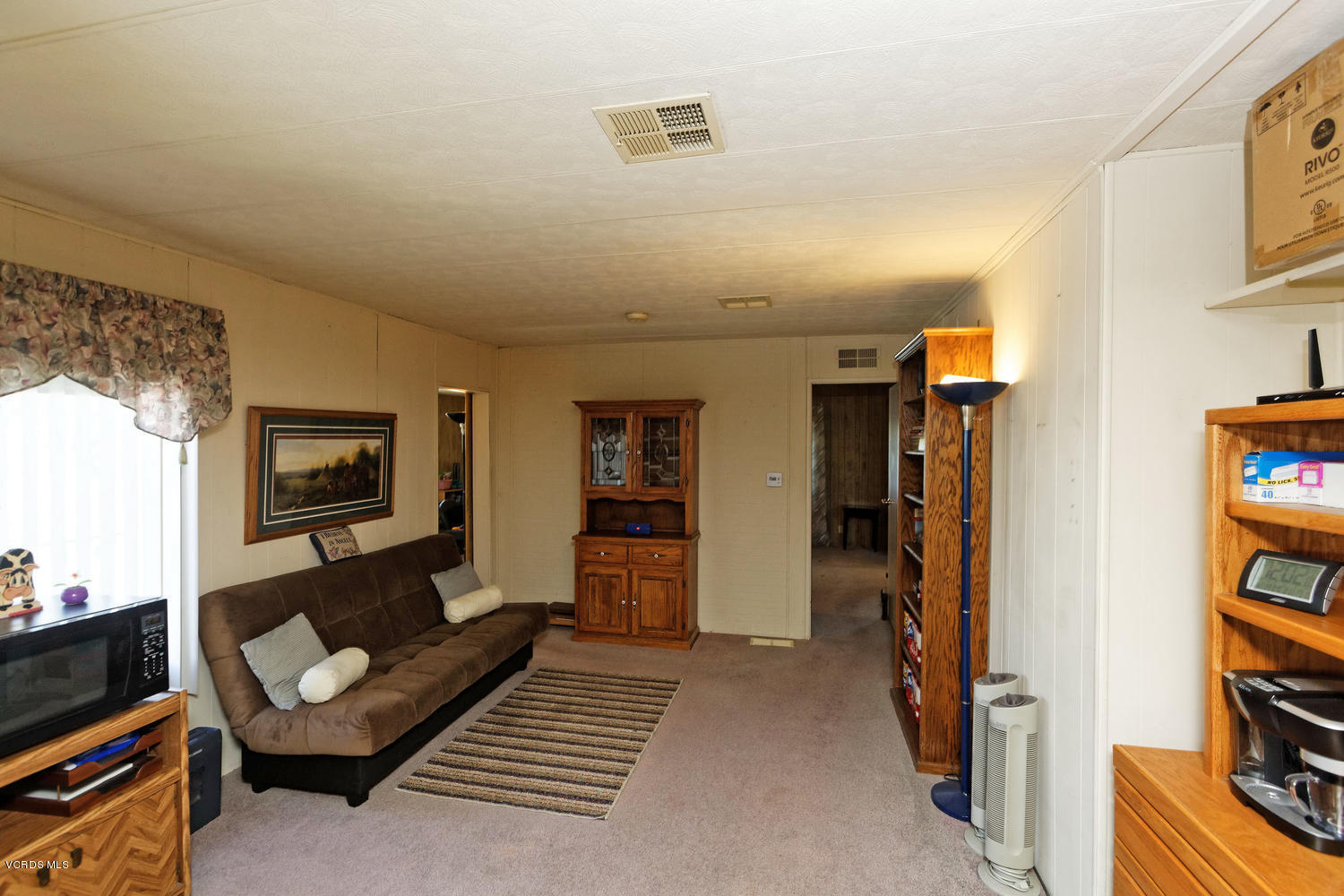 6480 Katherine Road, Unit 5 Simi Valley, CA 93063 - Photo 7 of 32 a living room with furniture and a book shelf