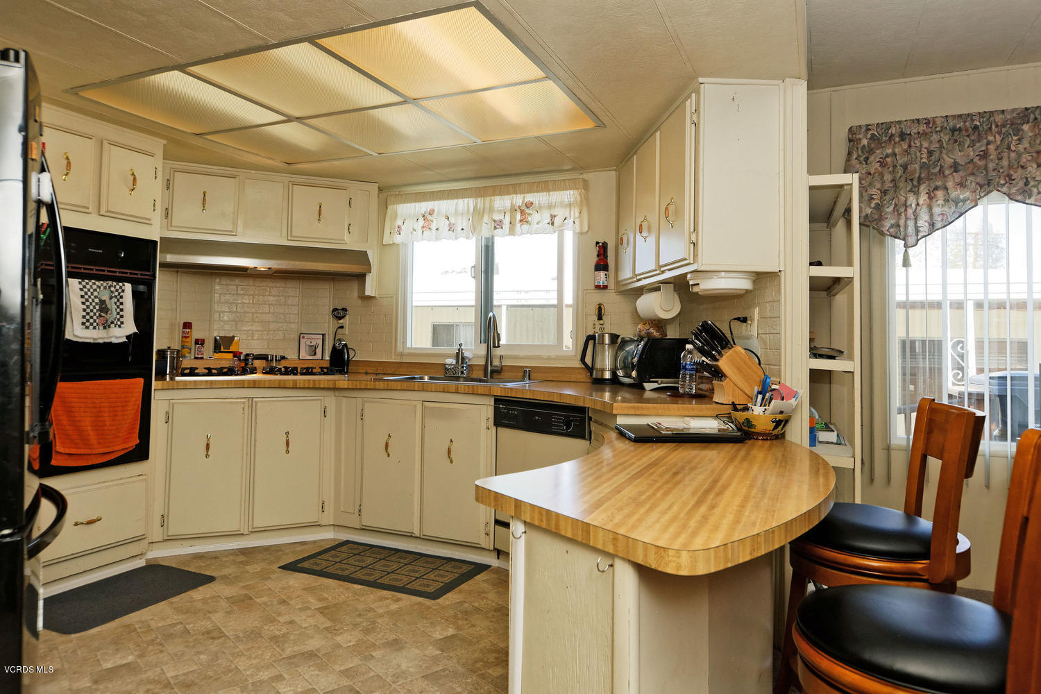 6480 Katherine Road, Unit 5 Simi Valley, CA 93063 - Photo 10 of 32 a kitchen with a sink appliances and cabinets